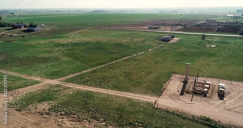 Rising shot of ranches near fracking pad and dairy fields Northern Colorado Weld County June 2022. photo