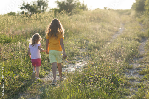 Two children are walking in nature