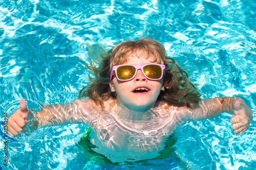 Kids summer vacation, swimming and relax. Happy child playing in swimming pool. Summer kids vacation.