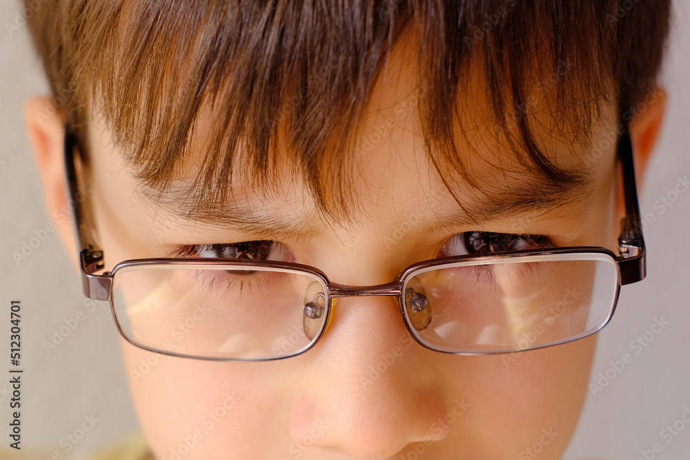 close-up of part of child's face, boy 10-12 years old in glasses, stress problems, difficult childhood, victim of domestic violence, in pain, health problems, psychological difficulties loneliness close-up of part of child's face, boy 10-12 years old in glasses, stress problems, difficult childhood, victim of domestic violence, in pain, health problems, psychological difficulties loneliness
