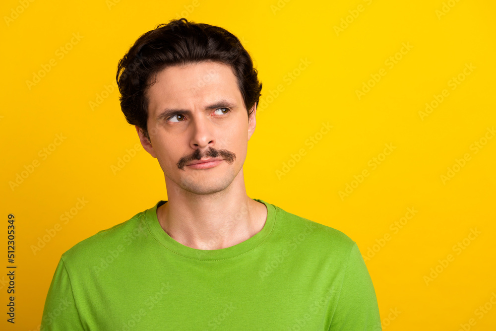 Fototapeta premium Photo of focused concentrated person calm face look interested empty space isolated on yellow color background