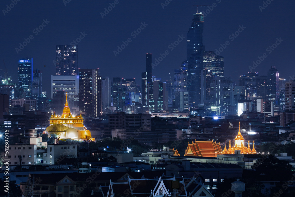 Night cityscape Golden Mountain and Wat Rachanaddaram temple, the main point landmark in Bangkok, Thailand.