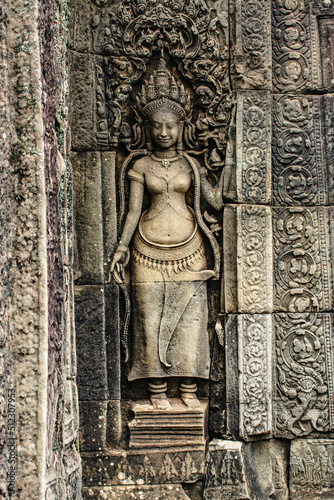 A sandstone sculpture of Apsara with a beautiful face and body at Bayon Angkor Thom Temple, Siem Reap, Cambodia.