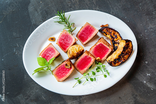grilled tuna on the white plate, top view