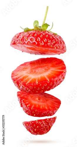 Strawberries cut into pieces flies on a white. Isolated