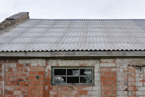 an old brick building with broken windows © Alena