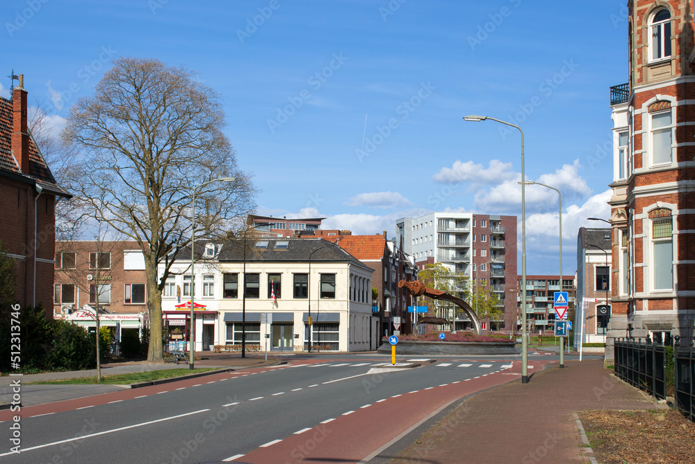 Oss, North Brabant, the Netherlands - April 10 2022: view on the Crooked Sword roundabout with on the right museum Jan Cunen (Villa Constance) and in the back the apartment complexes of Berghkwartier. Oss, North Brabant, the Netherlands - April 10 2022: view on the Crooked Sword roundabout with on the right museum Jan Cunen (Villa Constance) and in the back the apartment complexes of Berghkwartier.