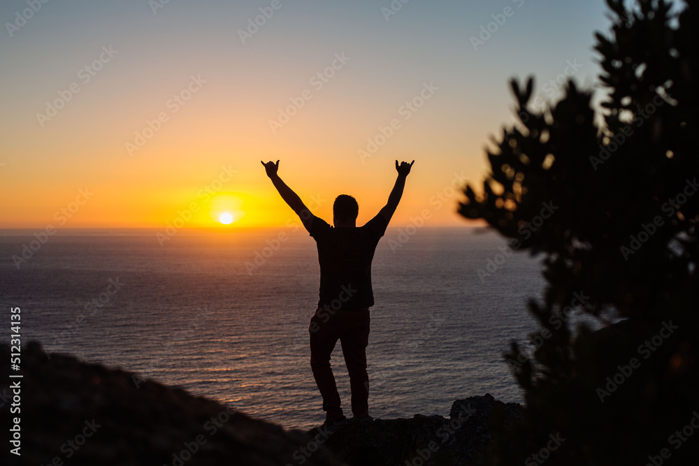 silhouette of a person with arms up 