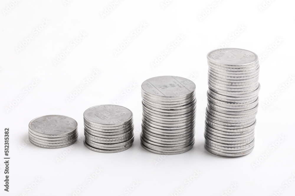 Stack of coins against white background - Money growth concept Stack of coins against white background - Money growth concept