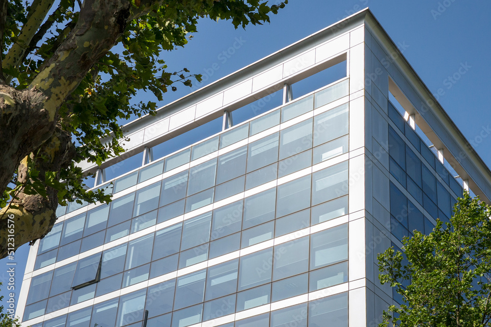 Facade of a glass building in the Eur district in Rome, Italy. There are many offices.