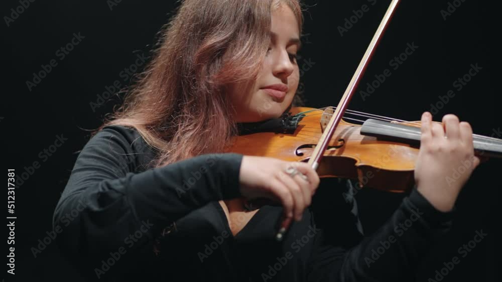woman violin player is playing fiddle in music hall, young female violinist in opera house woman violin player is playing fiddle in music hall, young female violinist in opera house