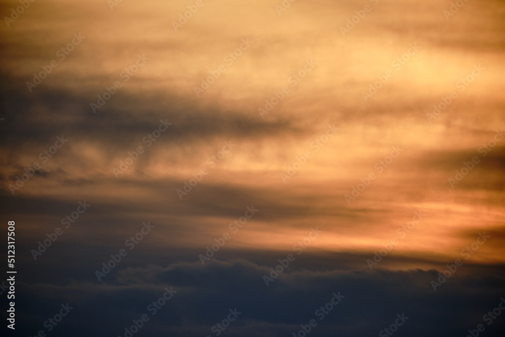 Evening dramatic sky with beige clouds during sunset