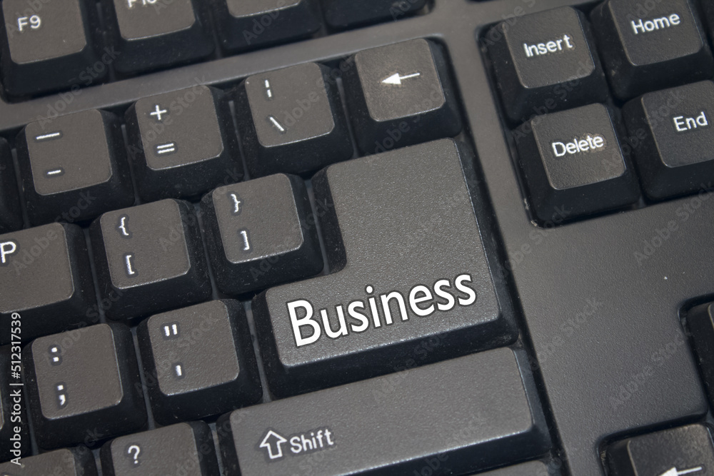 Black Computer Keyboard with Business text. Close-up of an electronic Computer Device part, keypad. Black Computer Keyboard with Business text. Close-up of an electronic Computer Device part, keypad.