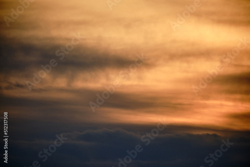 Evening dramatic sky with beige clouds during sunset
