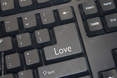 Black Computer Keyboard with Love text. Close-up of an electronic Computer Device part, keypad.