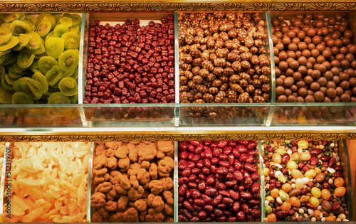 Turkish beautiful colorful delights,nuts in chocolate,dried fruits, top view. Sweet food background