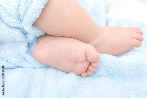 cute baby boy feet on a blue blanket © Studio 888