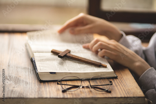 Close-up of hands on the Bible. The process of studying the Bible. Prayer and worship of God. Study of the Holy Scriptures. Studying in theological seminary. Theology. photo