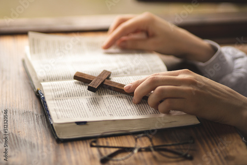 Close-up of hands on the Bible. The process of studying the Bible. Prayer and worship of God. Study of the Holy Scriptures. Studying in theological seminary. Theology. photo