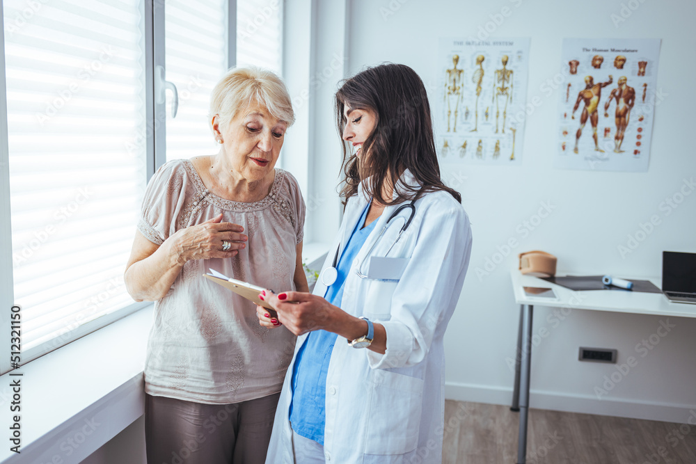 Fototapeta premium Smiling caring young female nurse doctor caretaker assisting happy senior grandma helping old patient in rehabilitation recovery at medical checkup visit, elder people healthcare homecare concept