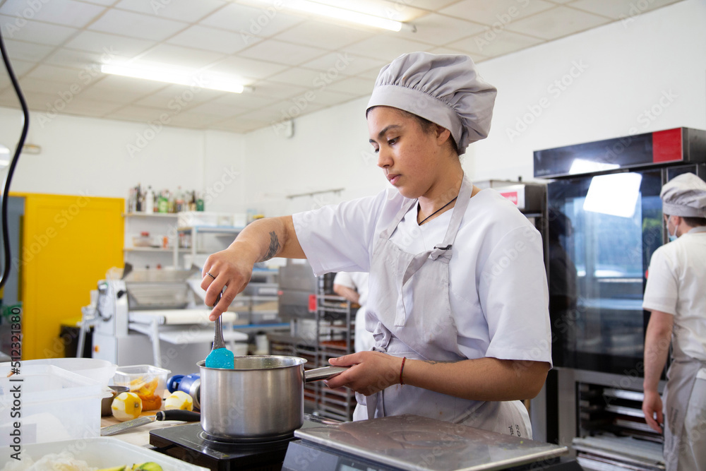 Woman stirring ingredients in saucepan Woman stirring ingredients in saucepan