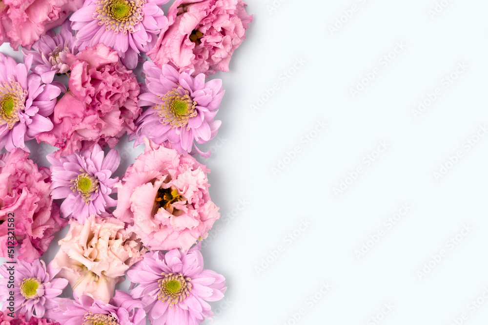 Eustoma and aster flower texture on a blue background. Greeting card concept for springtime holidays. Floral frame. Eustoma and aster flower texture on a blue background. Greeting card concept for springtime holidays. Floral frame.