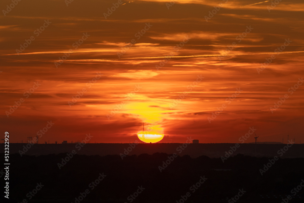 Fototapeta premium A golden sunset over the rolling hills in Banholt, south Limburg in the Netherlands creating holiday vibes. The views and the warm glow over the landscape create a feeling of being in the Mediterranea