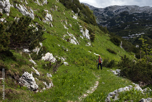 Female Adult Hiker Solo Ascent on Alpine Trail Footpath of World War One in Slovene Julian Alps