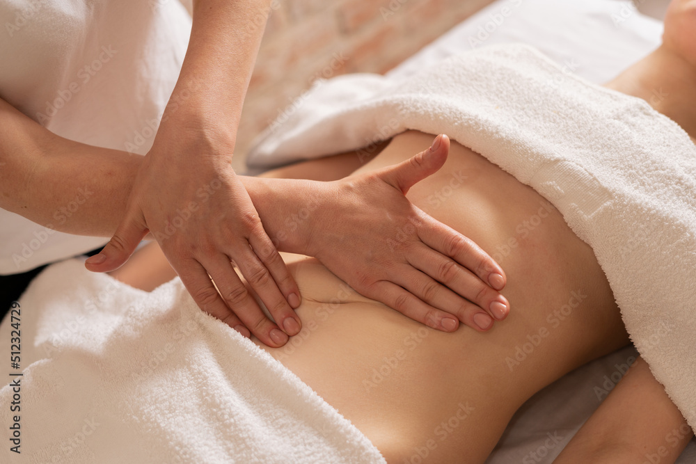 relaxing massage and body shaping massage, lymphatic drainage, manual and  aesthetic procedures, hands massaging belly in the spa Stock Photo | Adobe  Stock