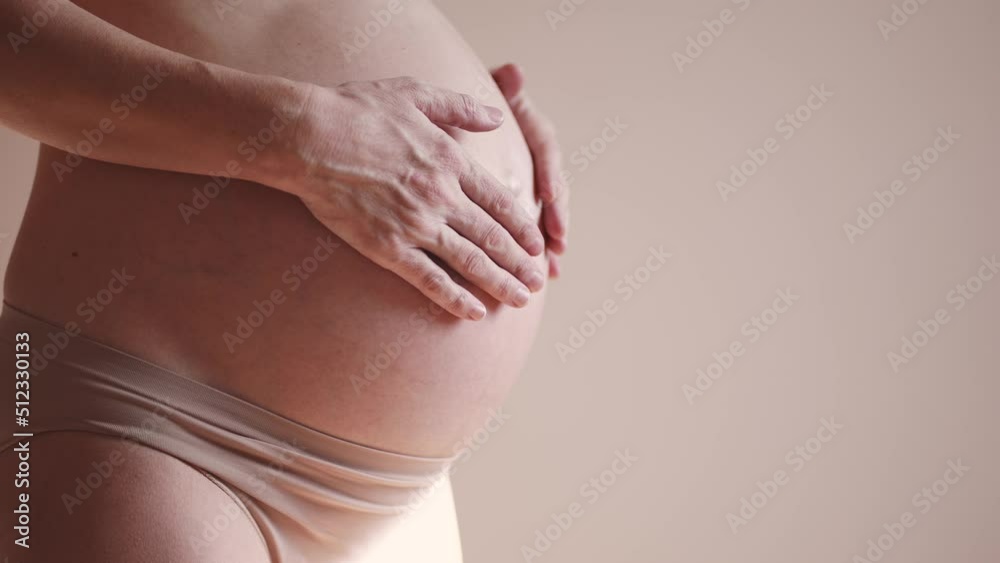 pregnant woman. health pregnancy motherhood procreation concept. close-up belly of sunlight a pregnant woman. woman waiting for a newborn baby. pregnant woman holding her belly indoors pregnant woman. health pregnancy motherhood procreation concept. close-up belly of sunlight a pregnant woman. woman waiting for a newborn baby. pregnant woman holding her belly indoors