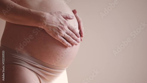 Wallpaper Mural pregnant woman. health pregnancy motherhood procreation concept. close-up belly of sunlight a pregnant woman. woman waiting for a newborn baby. pregnant woman holding her belly indoors Torontodigital.ca