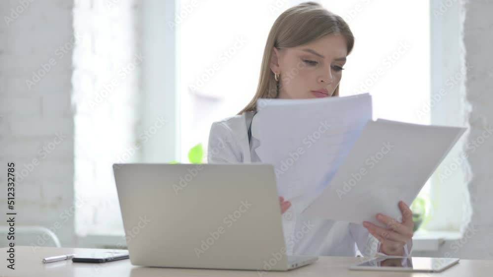 Lady Doctor Working on Medical Report and Laptop in Clinic Lady Doctor Working on Medical Report and Laptop in Clinic