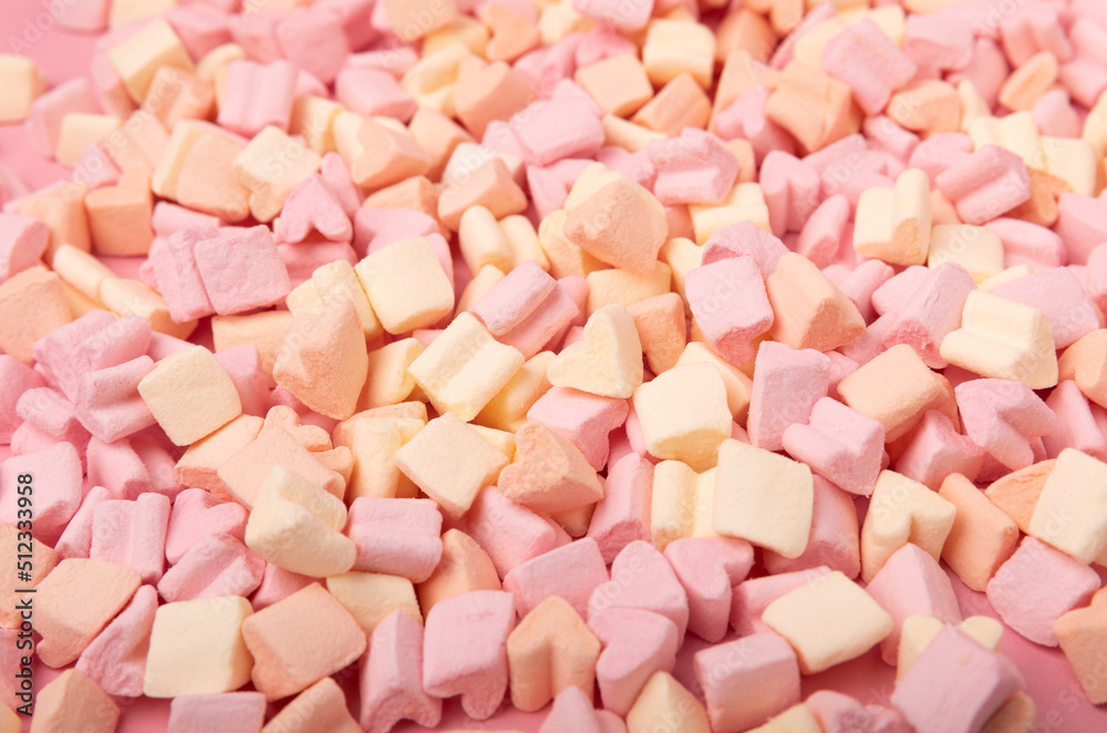 Fruit marshmallows in bulk on a pink background.Sweets and snacks for a snack.Chewy candy close-up.Space for copy.Place for text. Fruit marshmallows in bulk on a pink background.Sweets and snacks for a snack.Chewy candy close-up.Space for copy.Place for text.