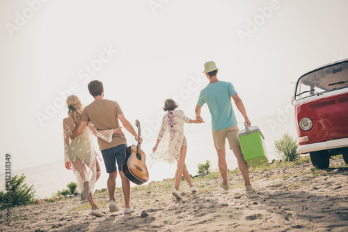 Photo of best buddies walk hold hands enjoy summer love life wear casual outfit nature seaside beach outdoors