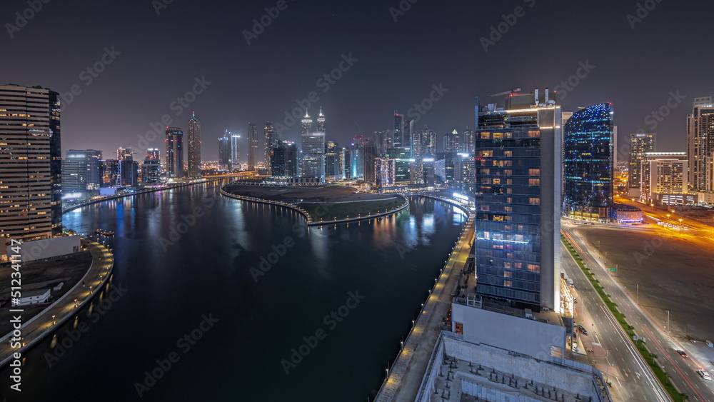 Obraz premium Panorama showing cityscape of skyscrapers in Dubai Business Bay with water canal aerial night timelapse