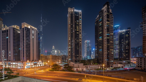 Aerial panoramic view to Dubai downtown and difc skyscrapers night timelapse.