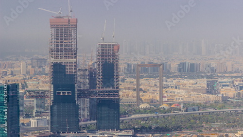 Aerial view of skyscrapers under construction in Dubai timelapse.