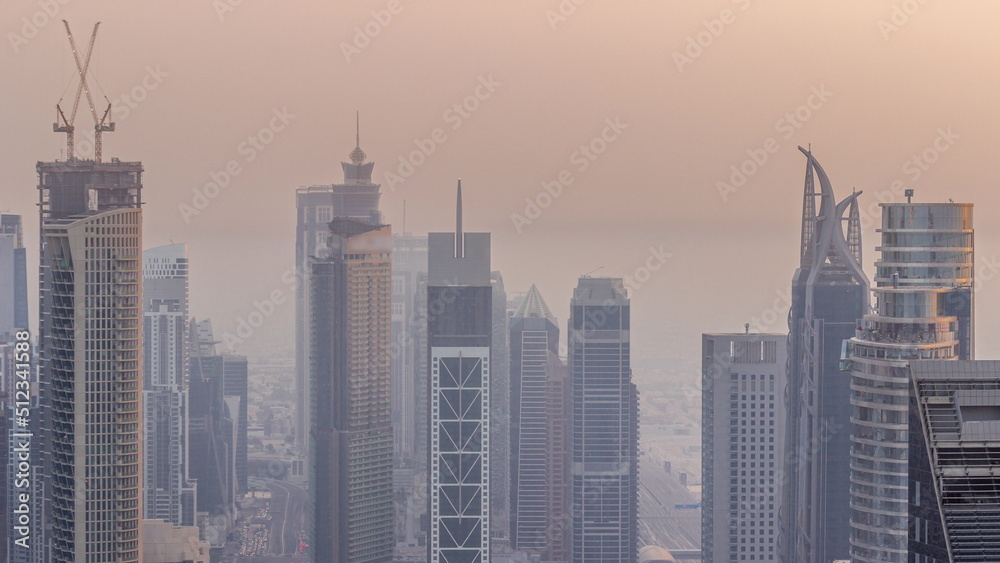 Downtown skyline with modern architecture form above timelapse. Aerial view of Dubai business bay towers.