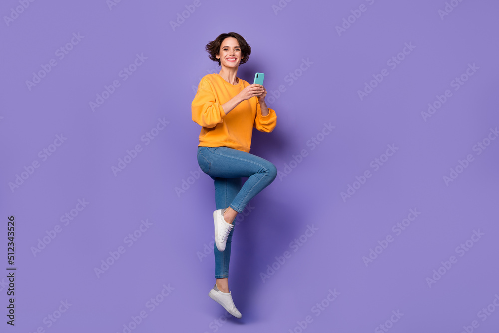 Full length body size view of attractive cheerful girl jumping using gadget blog 5g smm isolated over violet lilac color background