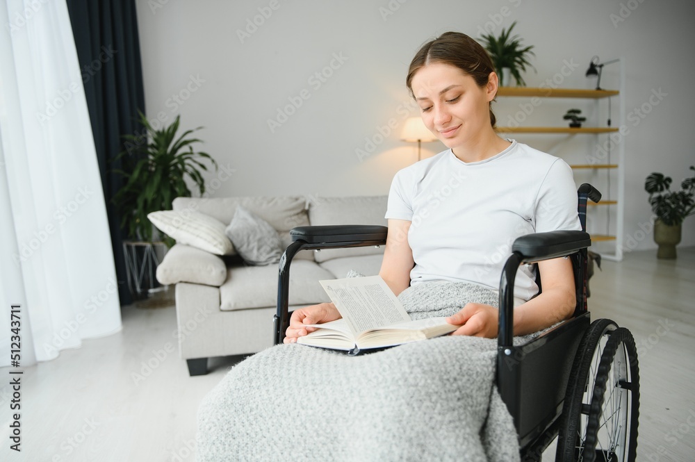 Young woman in wheelchair at home