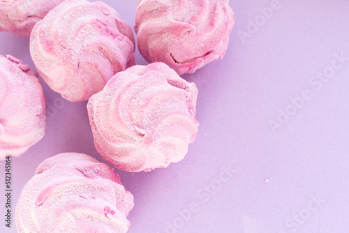 Homemade pink marshmallow - zephyr on a light lilac background