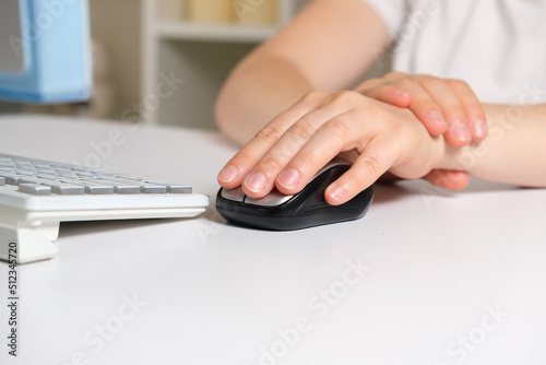 Human hand and computer mouse, carpal tunnel syndrome, wrist pain.