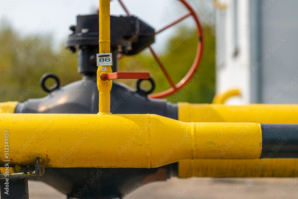 Two black and yellow gas pipes are connected by large bolts.Background for suppliers of gas products and pipes.Close-up,selective focus. Two black and yellow gas pipes are connected by large bolts.Background for suppliers of gas products and pipes.Close-up,selective focus.