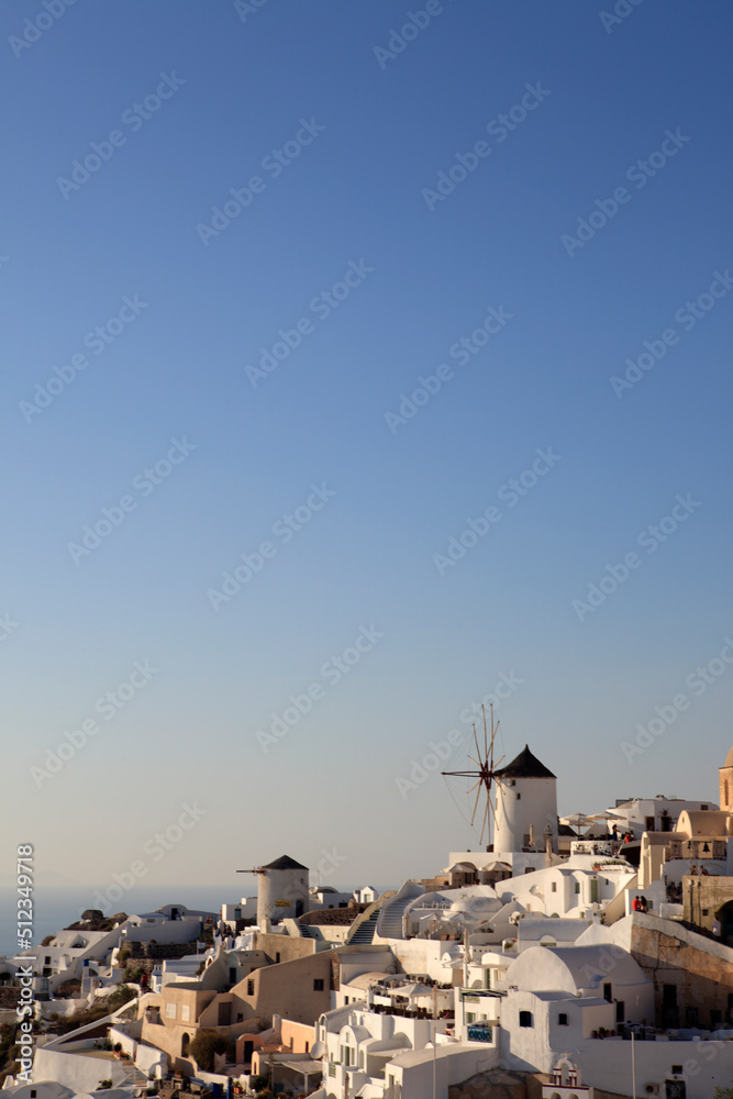 Naklejka premium Traditional windmills in Oia in Santorini, Greece