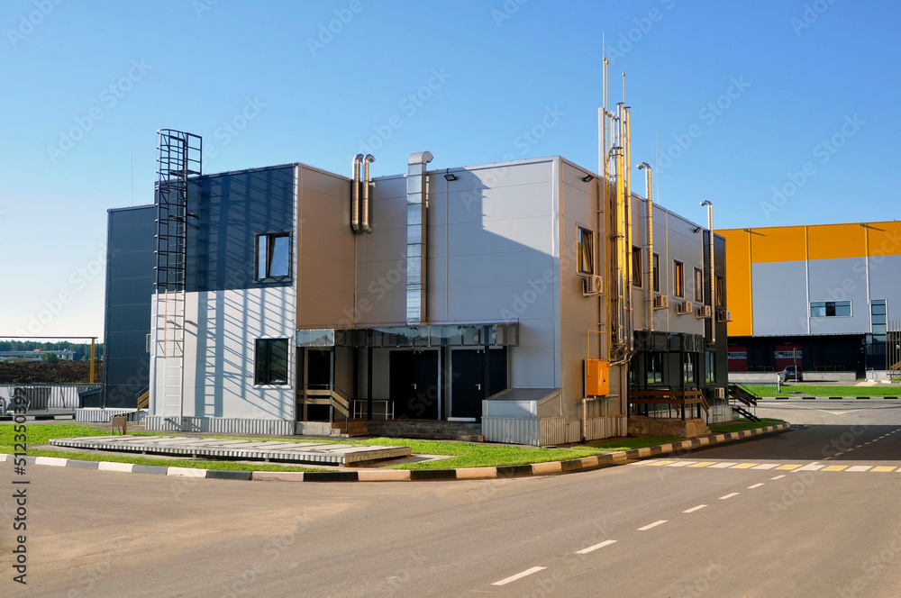 A modern prefabricated office building made of steel structures, sheathed with sandwich panels.