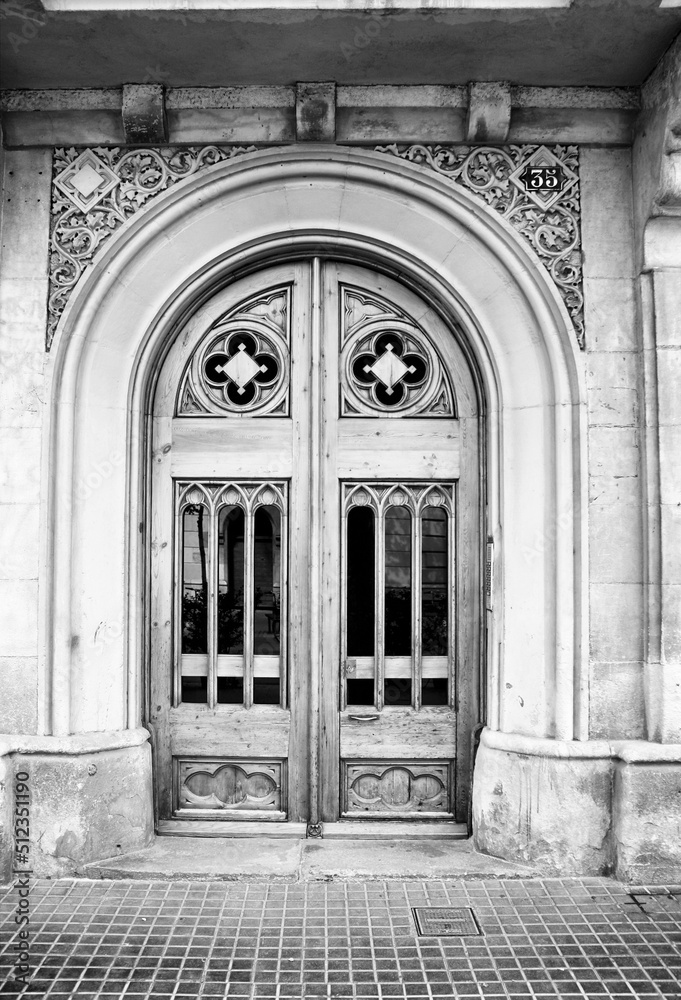 Barcelona door in Eixample district. Retro style photo black and white BW. Barcelona landmarks.