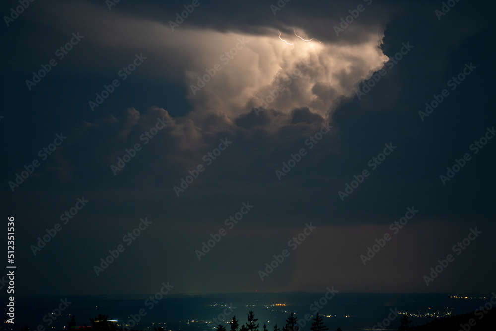 Thunderstorm in the Bavarian Forest with dark clouds and bright sheet lightning