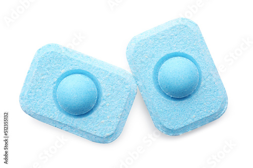Two water softener tablets on white background