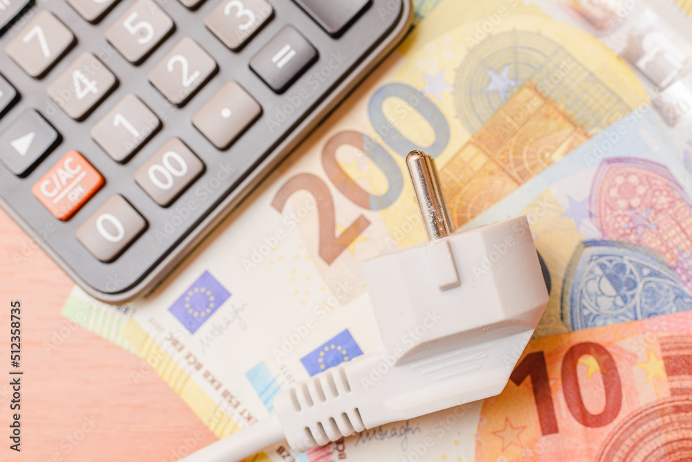 Electric Plug,euro banknotes,calculator flat laying on the table.The  concept of rising electricity prices.Top view. Stock Photo | Adobe Stock