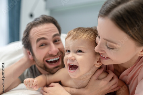 Close-up of joyful faces of baby man and woman
